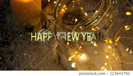 Image of happy new year text over snow falling and christmas fairy lights 123643792