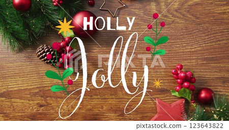 Image of holly jolly text over christmas decorations on wooden background Image of holly jolly text over christmas decorations on wooden background 123643822