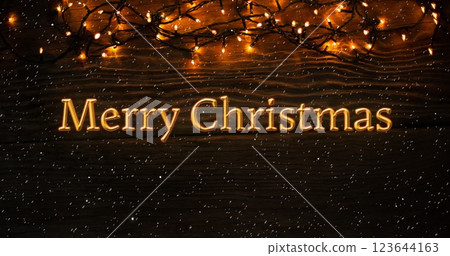 Image of merry christmas text over snow falling with christmas decorations 123644163