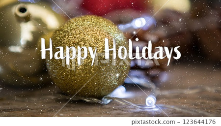 Image of happy holidays text over snow falling with christmas decorations Image of happy holidays text over snow falling with christmas decorations 123644176