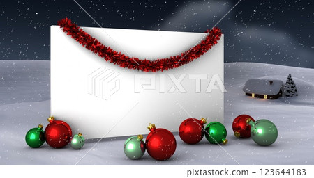 Image of snow falling over white card with copy space and christmas decorations Image of snow falling over white card with copy space and christmas decorations 123644183