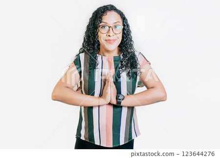 Young woman in glasses asking for a favor isolated. Latin girl asking for help with her hands isolated Young woman in glasses asking for a favor isolated. Latin girl asking for help with her hands isolated 123644276