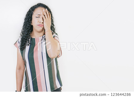 Stressed young woman holding her forehead. Stressed people with palm on forehead isolated. Worried young woman holding his forehead 123644286