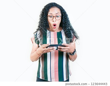 Amazed afro girl holding and looking phone shocked. Surprised afro young woman looking at a promotion on the phone isolated Amazed afro girl holding and looking phone shocked. Surprised afro young woman looking at a promotion on the phone isolated 123644443
