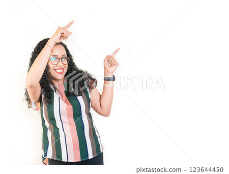 Happy afro young woman pointing an advertising side. Beautiful afro girl pointing to a banner to the side. Happy people pointing a promo isolated 123644450