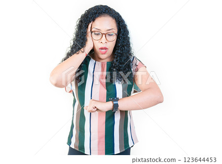 Surprised afro young woman looking at wrist watch. Worried afro girl looking at her watch isolated 123644453