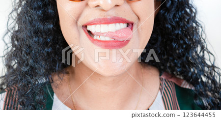 Close up of Girl mouth biting her tongue isolated. Close up of sexy girl biting tongue 123644455