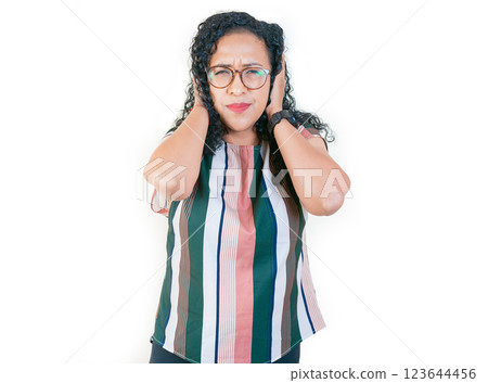 Displeased  afro girl in glasses covering her ears isolated. Young afro woman covering her ears tightly 123644456