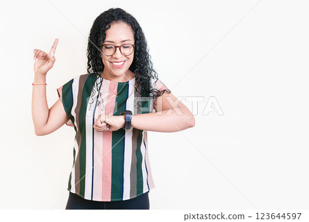 Happy young woman looking at hand watch isolated. Girl in glasses measuring time with hand watch 123644597