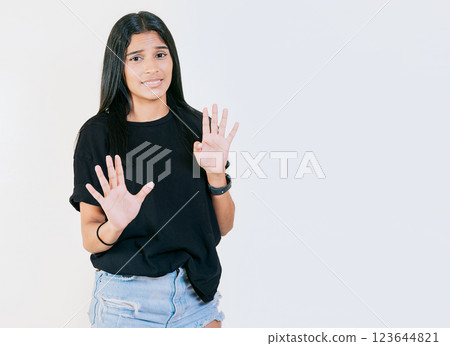Displeased teenage girl rejecting with palms hands isolated. Disgusted young girl with rejection gesture. He frowns in disgust 123644821