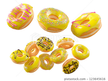 Donuts with yellow lemon glaze, sprinkles, white drizzle, and dots isolated on white transparent background 123645616