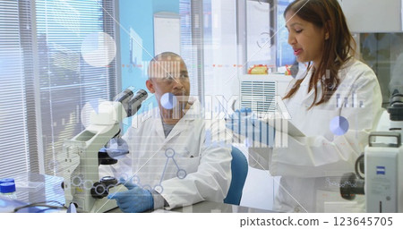 Image of financial data processing over diverse scientists working in lab 123645705