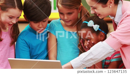 Image of diverse schoolchildren using laptop over school items icons 123647135