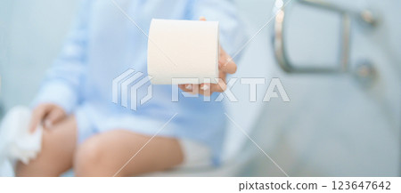 Woman holding toilet paper roll while sitting on toilet bowl. digestion, constipation, Diarrhea from food poisoning, infection, abdominal, stomachache, cystitis, Insurance, Health care and Medical Woman holding toilet paper roll while sitting on toilet bowl. digestion, constipation, Diarrhea from food poisoning, infection, abdominal, stomachache, cystitis, Insurance, Health care and Medical 123647642