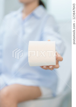Woman holding toilet paper roll while sitting on toilet bowl. digestion, constipation, Diarrhea from food poisoning, infection, abdominal, stomachache, cystitis, Insurance, Health care and Medical Woman holding toilet paper roll while sitting on toilet bowl. digestion, constipation, Diarrhea from food poisoning, infection, abdominal, stomachache, cystitis, Insurance, Health care and Medical 123647643