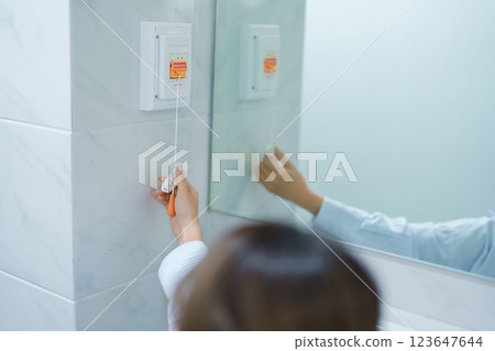 woman Patient hand holding and pulling emergency button in toilet of hospital room, calling nurse in emergency case. Professional Medical system and Safety Alert woman Patient hand holding and pulling emergency button in toilet of hospital room, calling nurse in emergency case. Professional Medical system and Safety Alert 123647644