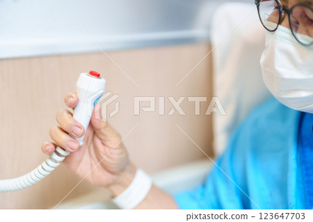 Elderly woman Patient hand holding and pressing emergency button in hospital room, calling nurse in emergency case. Professional Medical system and Safety Alert 123647703