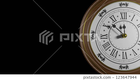 Image of retro clock ticking showing midnight on black background 123647944