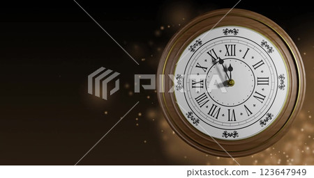 Image of retro clock ticking showing midnight with spots of light on black background 123647949