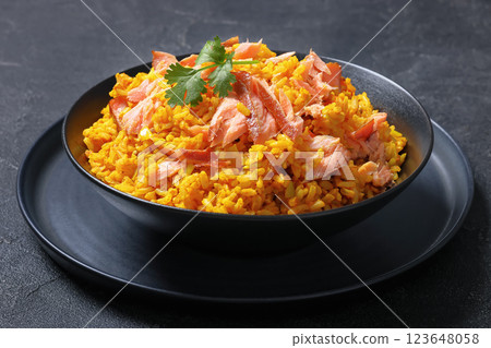hot smoked salmon kedgeree in a black bowl hot smoked salmon kedgeree in a black bowl 123648058