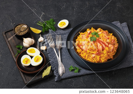 hot smoked salmon kedgeree in a black bowl hot smoked salmon kedgeree in a black bowl 123648065