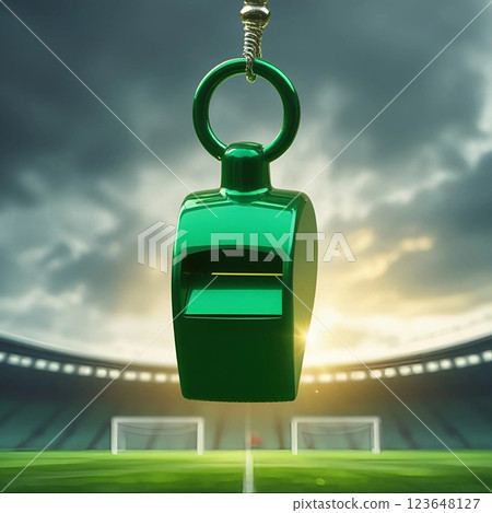 Green whistle hanging in a stadium with dramatic sky.  123648127