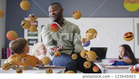 Image of emoji icons over diverse schoolchildren and teacher 123648403