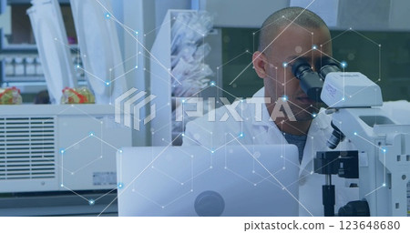 Image of network of connections over biracial male scientist Image of network of connections over biracial male scientist 123648680