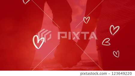 Image of white hearts over caucasian couple holding hands on beach Image of white hearts over caucasian couple holding hands on beach 123649220