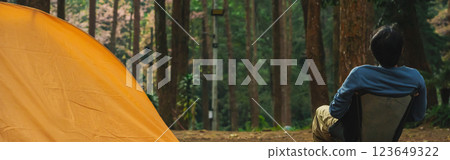 solo traveler in nature concept with asian man camping and see pink cherry blossom tree and pine tree with sunrise in springtime season solo traveler in nature concept with asian man camping and see pink cherry blossom tree and pine tree with sunrise in springtime season 123649322