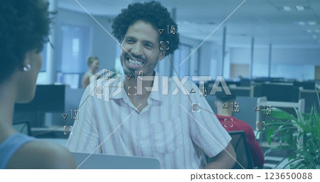 Image of data processing and diagrams over biracial colleagues discussing work in office 123650088
