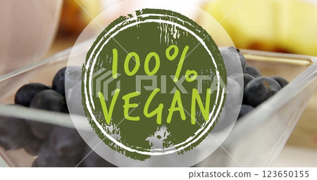 Image of 100 percent vegan text over blueberries on table 123650155