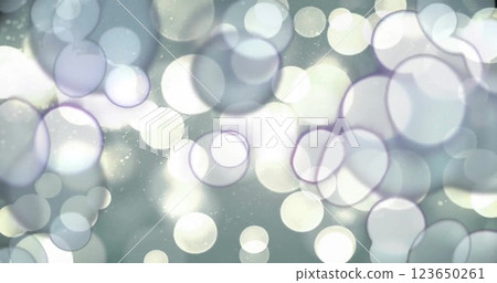 Image of glowing light spots moving over grey background 123650261