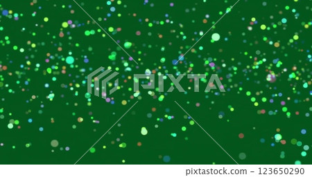 Image of glowing light spots over green background 123650290