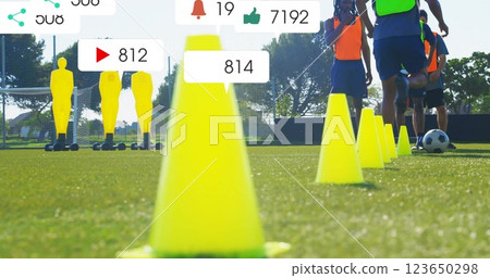 Image of social media notifications over african american male football team training with ball 123650298
