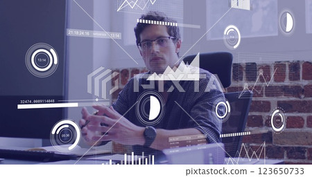 Image of financial data processing over caucasian businessman in office Image of financial data processing over caucasian businessman in office 123650733