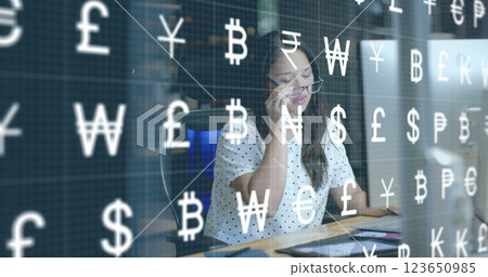 Image of currency icons and data processing over biracial businesswoman in office 123650985