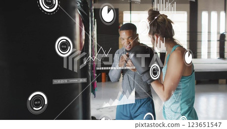 Image of data processing and diagrams over biracial couple boxing at gym Image of data processing and diagrams over biracial couple boxing at gym 123651547