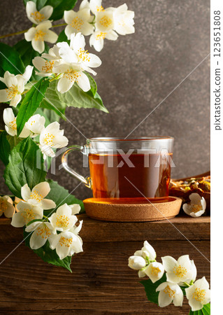 Herbal tea and blooming jasmine branch. 123651808