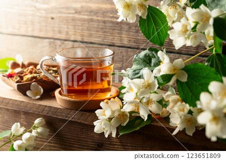 Herbal tea and blooming jasmine branch. 123651809