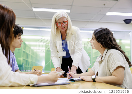 Foreign men and women having a meeting in an office Foreign men and women having a meeting in an office 123651956
