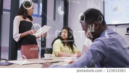 Image of data processing and diagrams over diverse colleagues discussing work in office Image of data processing and diagrams over diverse colleagues discussing work in office 123652061