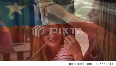 Image of flag of chile over caucasian mother and daughter brushing hair 123652213