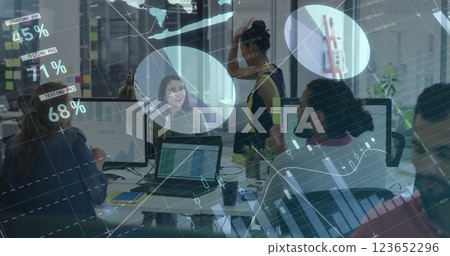 Image of financial data processing over diverse business people in office Image of financial data processing over diverse business people in office 123652296