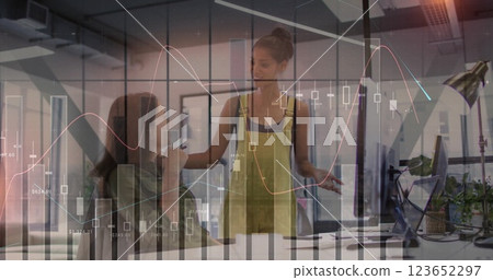Image of financial data processing over diverse business people in office Image of financial data processing over diverse business people in office 123652297