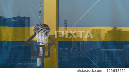 Image of silver house key over flag of sweden and cityscape 123652351
