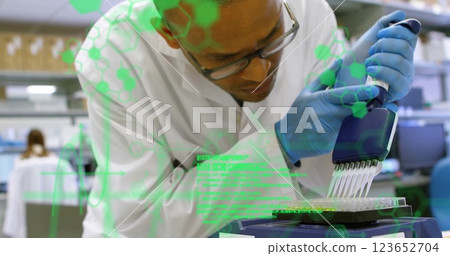 Image of scientific data processing over biracial male scientist in laboratory Image of scientific data processing over biracial male scientist in laboratory 123652704