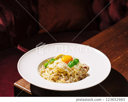 Delicious pasta dish with egg yolk and herbs served in a restaurant Delicious pasta dish with egg yolk and herbs served in a restaurant 123652983
