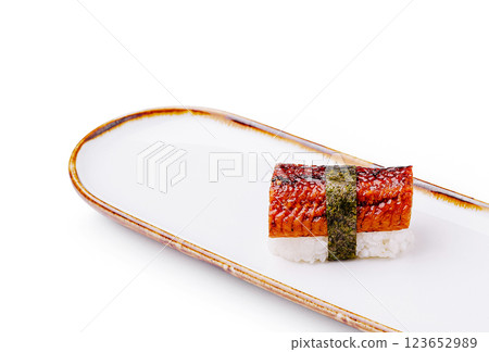 Sushi roll prepared with grilled eel on white plate 123652989