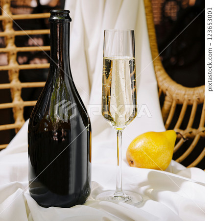 Sparkling drink and pear on soft white fabric settings Sparkling drink and pear on soft white fabric settings 123653001